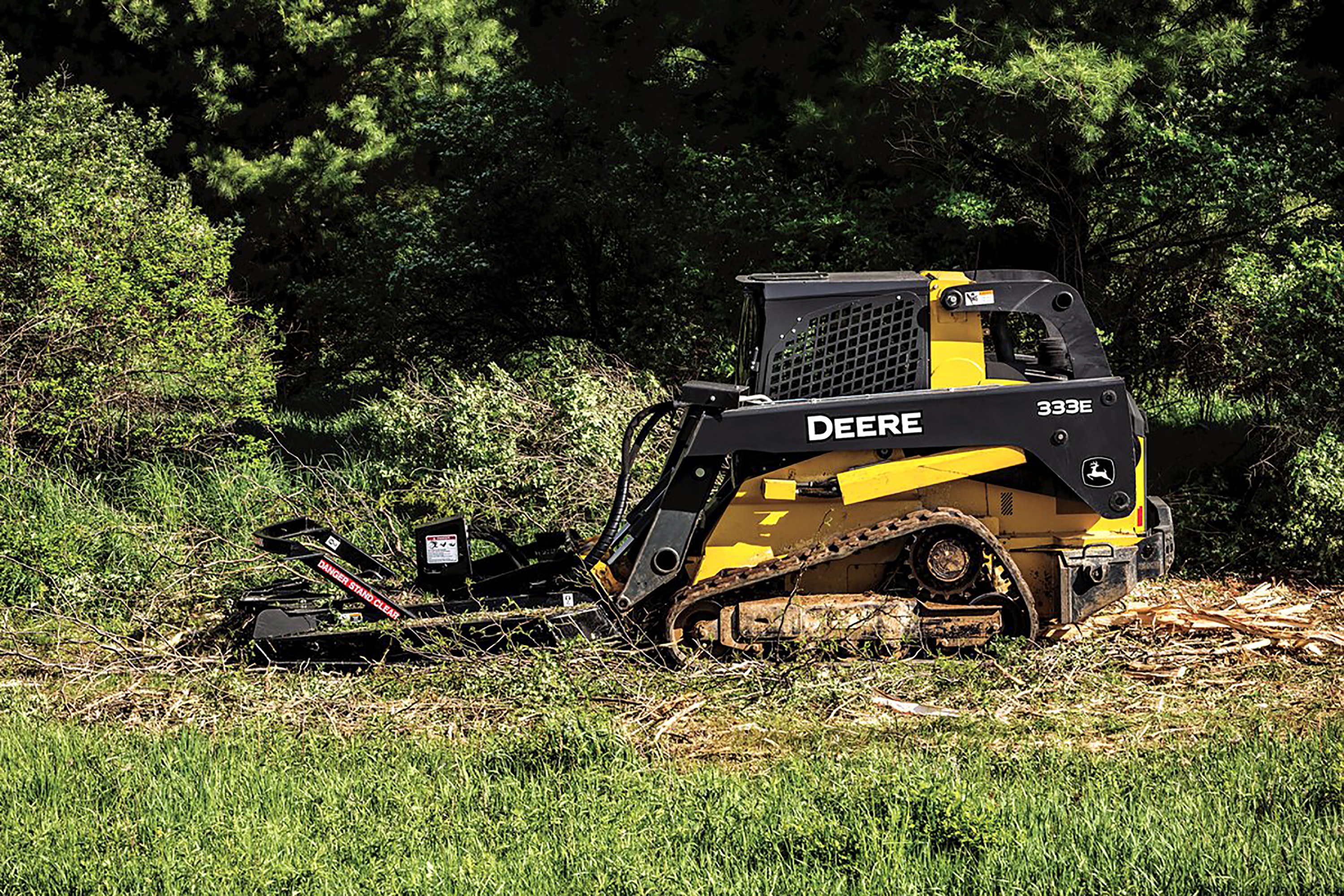 ... view of a John Deere CTL using an Extreme Duty Brush Cutter attachment