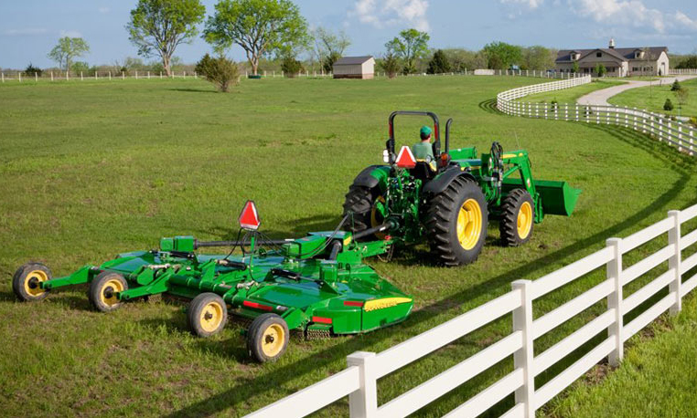John Deere tractor using a Medium-Duty Rotary Cutter to cut grass next ...