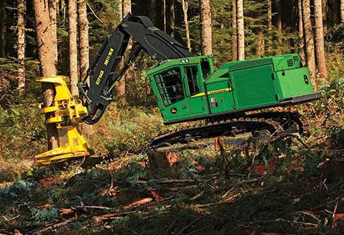 Left hand side view of the 903M Tracked Feller Buncher cutting a tree