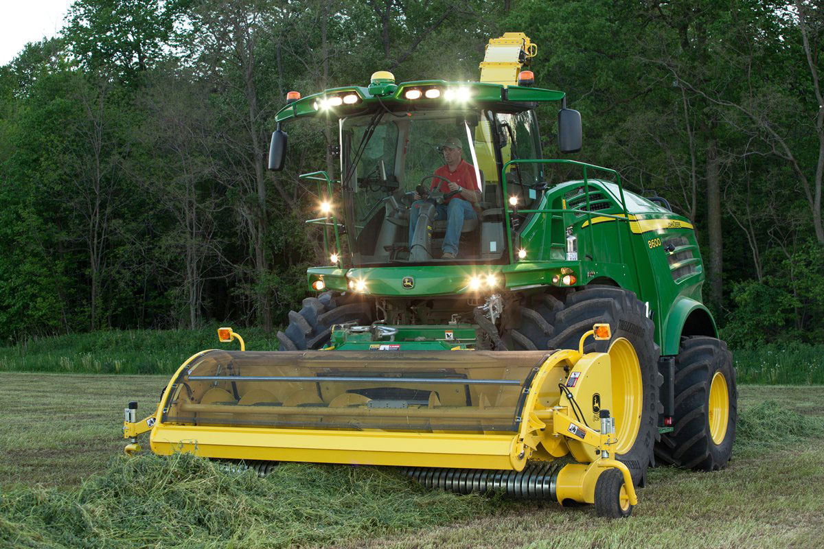 The 8000 Self-Propelled Forage Harvester with trees in the background