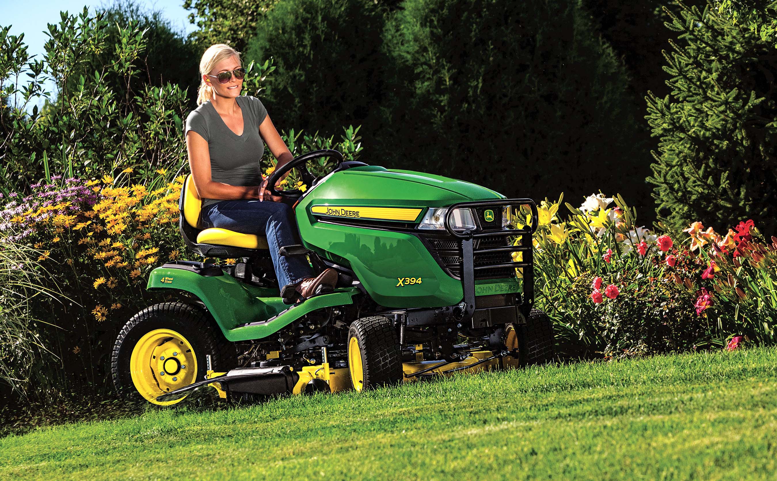 The John Deere X394 Select Series tractor mower has four-wheel ...