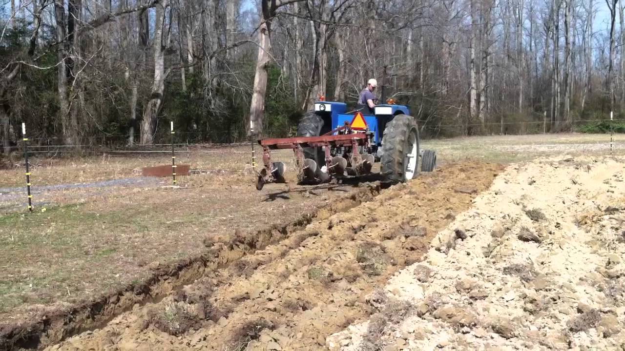 1310 long tractor pulling IH 4 bottom plow - YouTube
