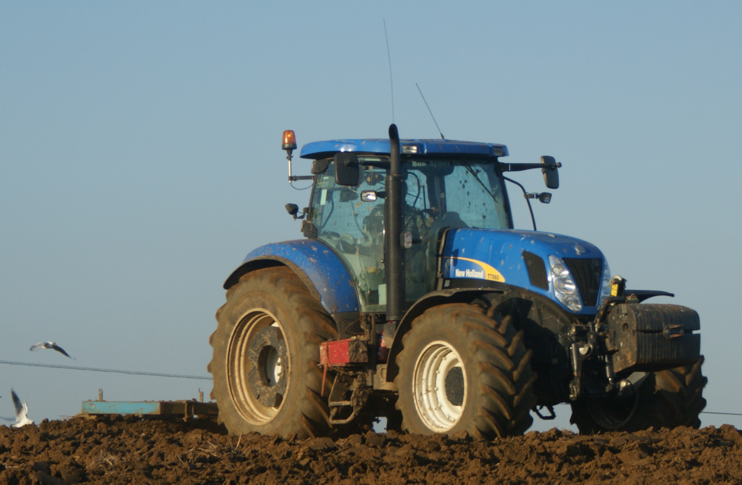Description New Holland T7060, Sandford Farm fields being cultivated ...