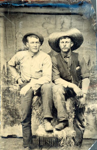 Antique photo of two ranch hands, circa 1890 - 1910.