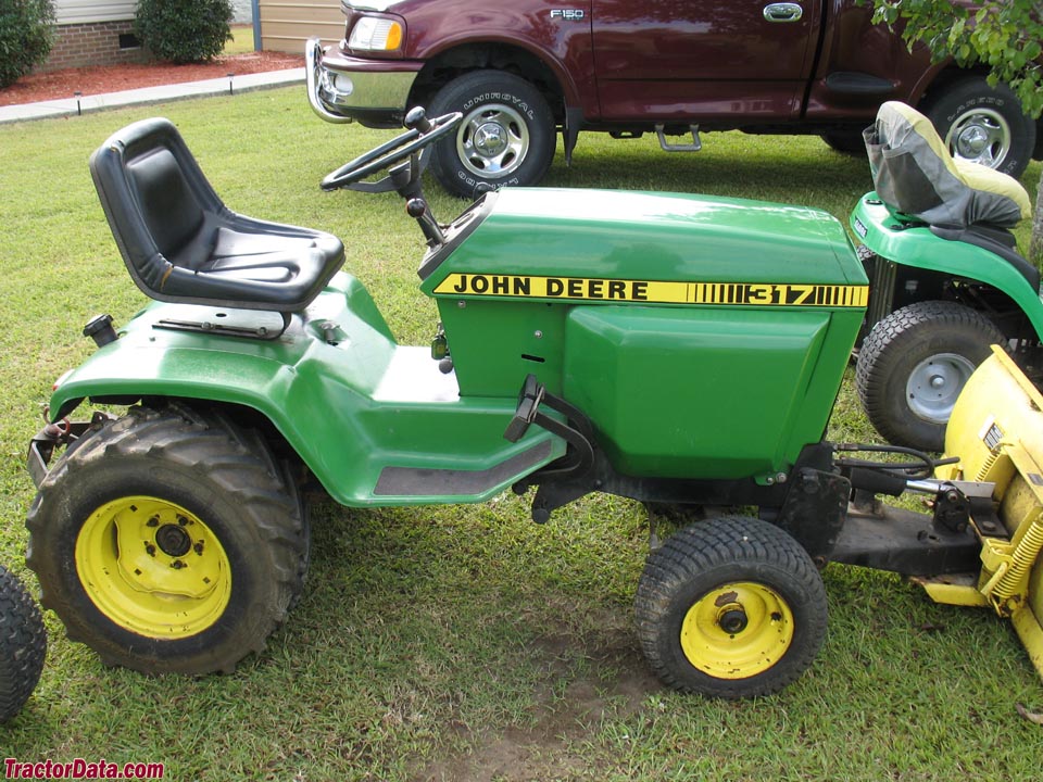 John Deere 317 with front blade and integral hitch. Photo courtesy of ...