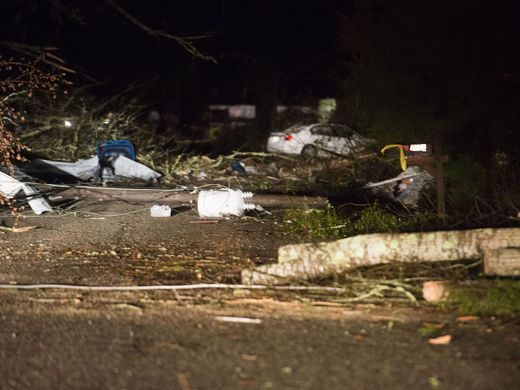 Wind blown debris litters the streets of Century; Fla. after a ...